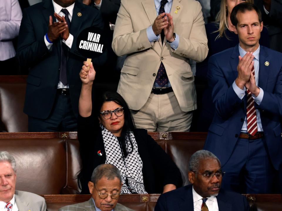 Rep. Rashida Tlaib of Michigan holds up a "War Criminal" sign during Netanyahu's address.