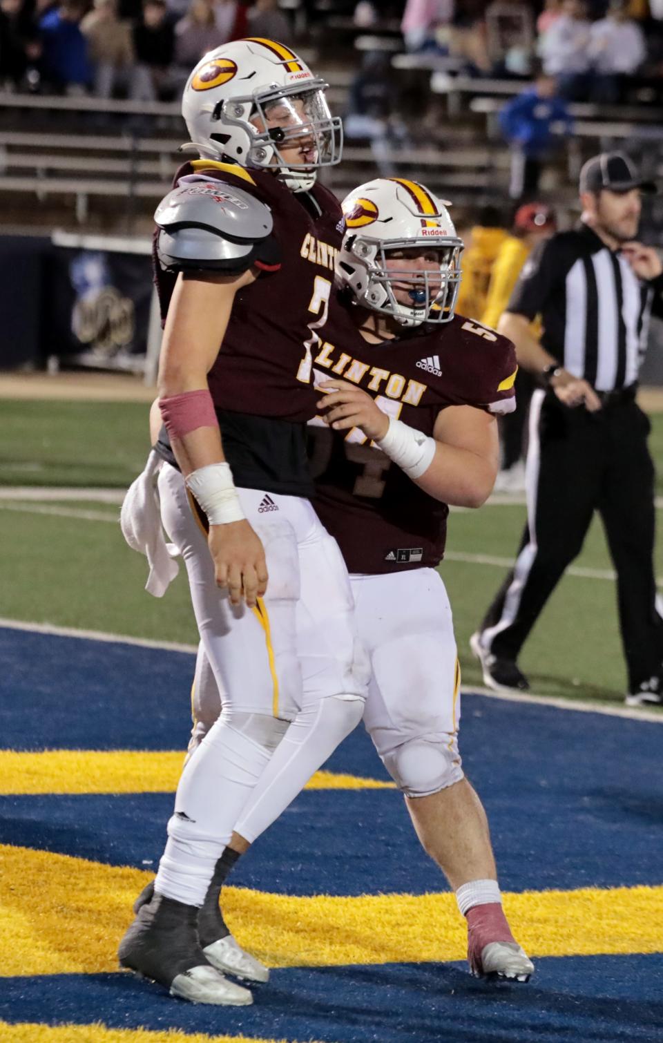 Clinton quarterback Caden Powell celebrates with lineman Layden Fuller in the Class 4A final Friday.