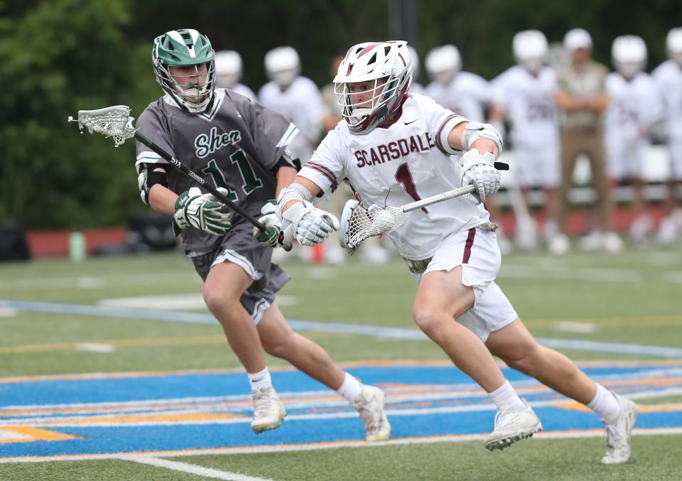 Scarsdale's Colby Baldwin (1) wins a face off with  Shenendehowa JT Wilders (11) during the state regional final at Mahopac High School June 3, 2023. Scarsdale won the game 10-9.