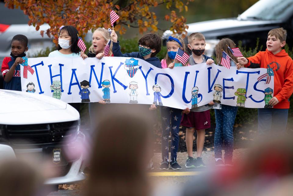 Students celebrate the veterans taking part in their Veterans Day parade at Sharon Elementary School in Newburgh, Ind., Thursday afternoon, Nov. 11, 2021.