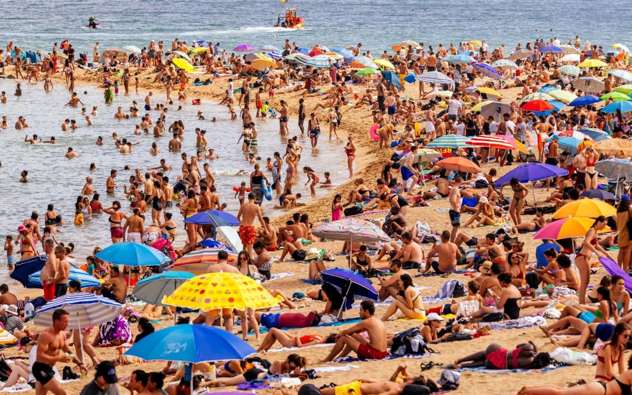 Crowds of tourist on Barceloneta beach