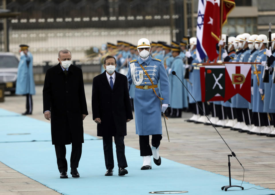 Turkish President Recep Tayyip Erdogan, left, and Israel's President Isaac Herzog inspect a military guard of honour during a welcome ceremony, in Ankara, Turkey, Wednesday, March 9, 2022. President Isaac Herzog is the first Israeli leader to visit Turkey since 2008. (AP Photo/Burhan Ozbilici)
