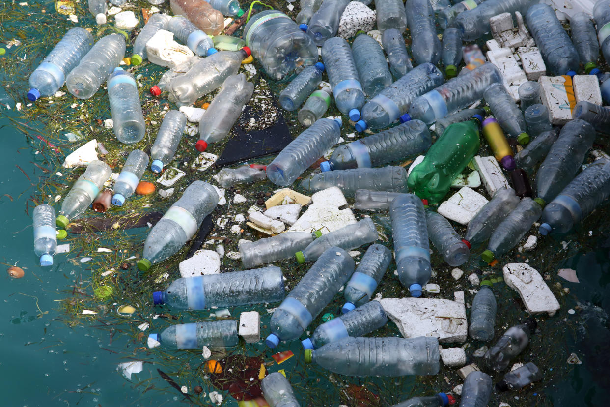 Marine pollution, mainly made up of plastic bottles and polystyrene floating in Hinnavaru Harbour, Maldives, Indian Ocean.