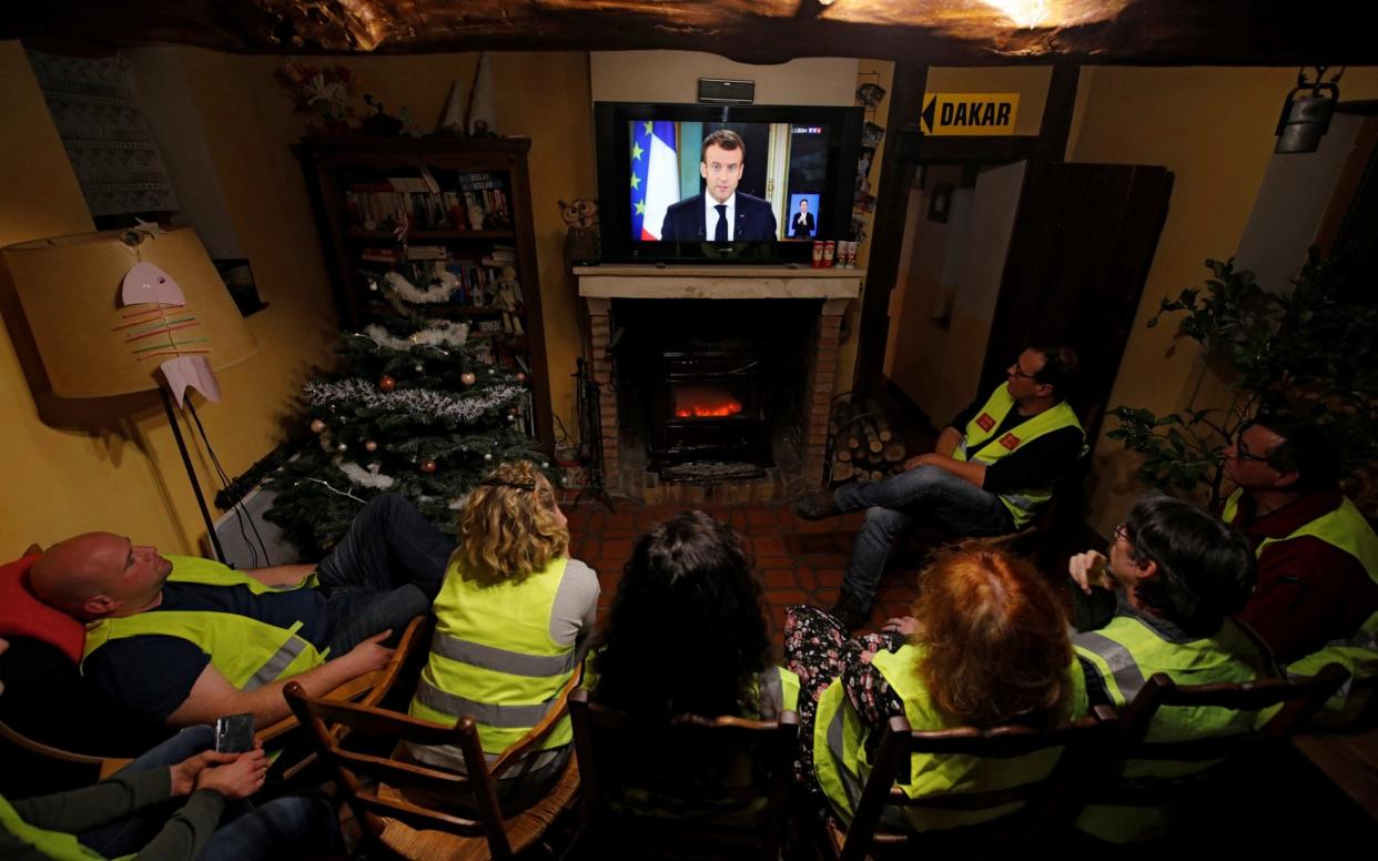 'Yellow vest' protesters watch Emmanuel Macron address the nation in a bid to quell the revolt gripping France - REUTERS