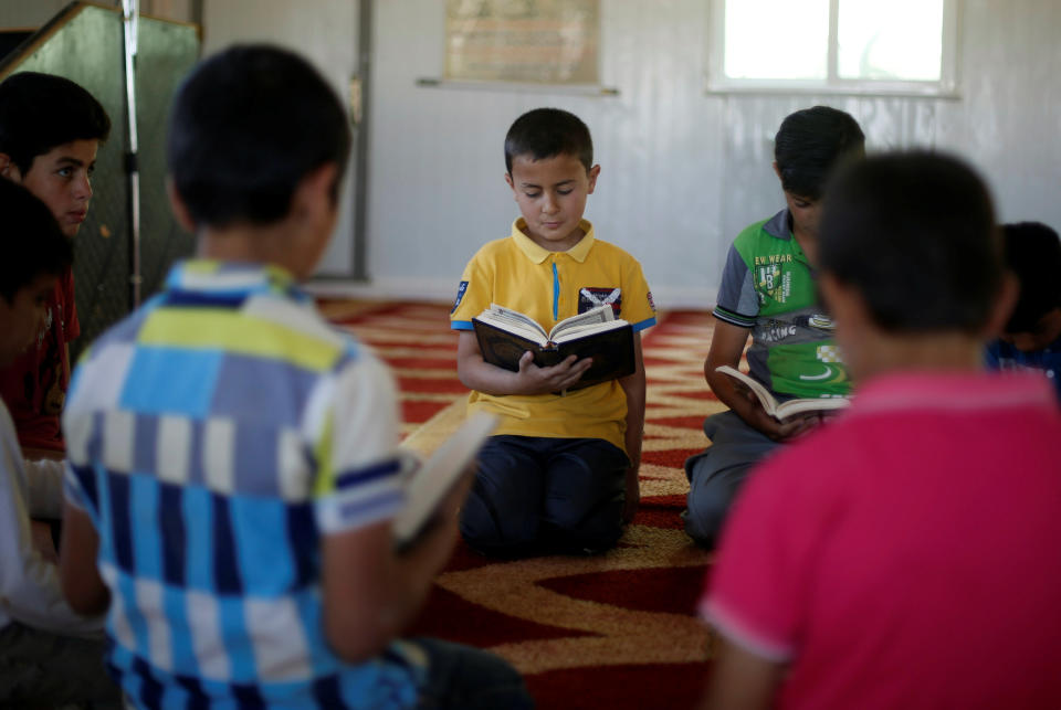 Syrian refugees boys read the Koran inside the Quran Memorization Center, during the Muslim fasting month of Ramadan at the Al-Zaatari camp near the border with Syria&nbsp;June 1.