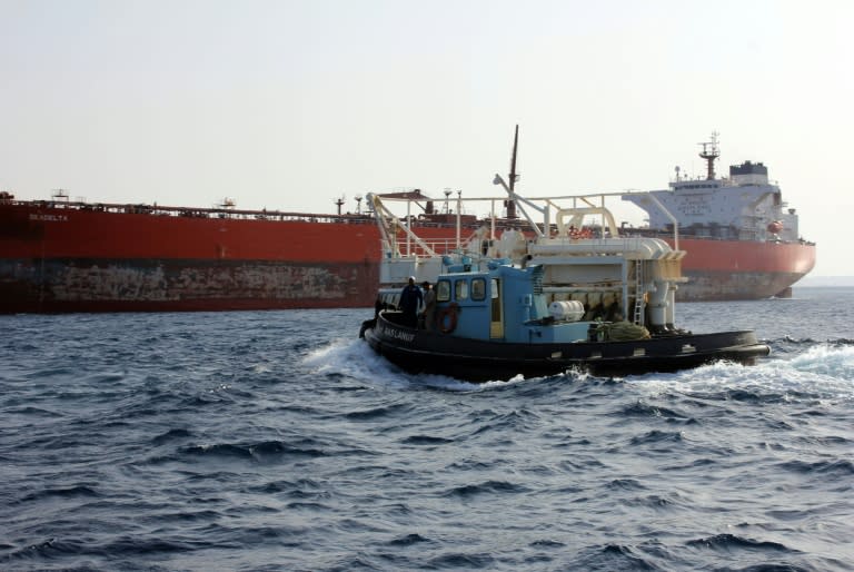 A tug boat approaches the Malta-flageed Seadelta oil tanker off the coast of Libya's eastern Ras Lanuf port, on September 19, 2016