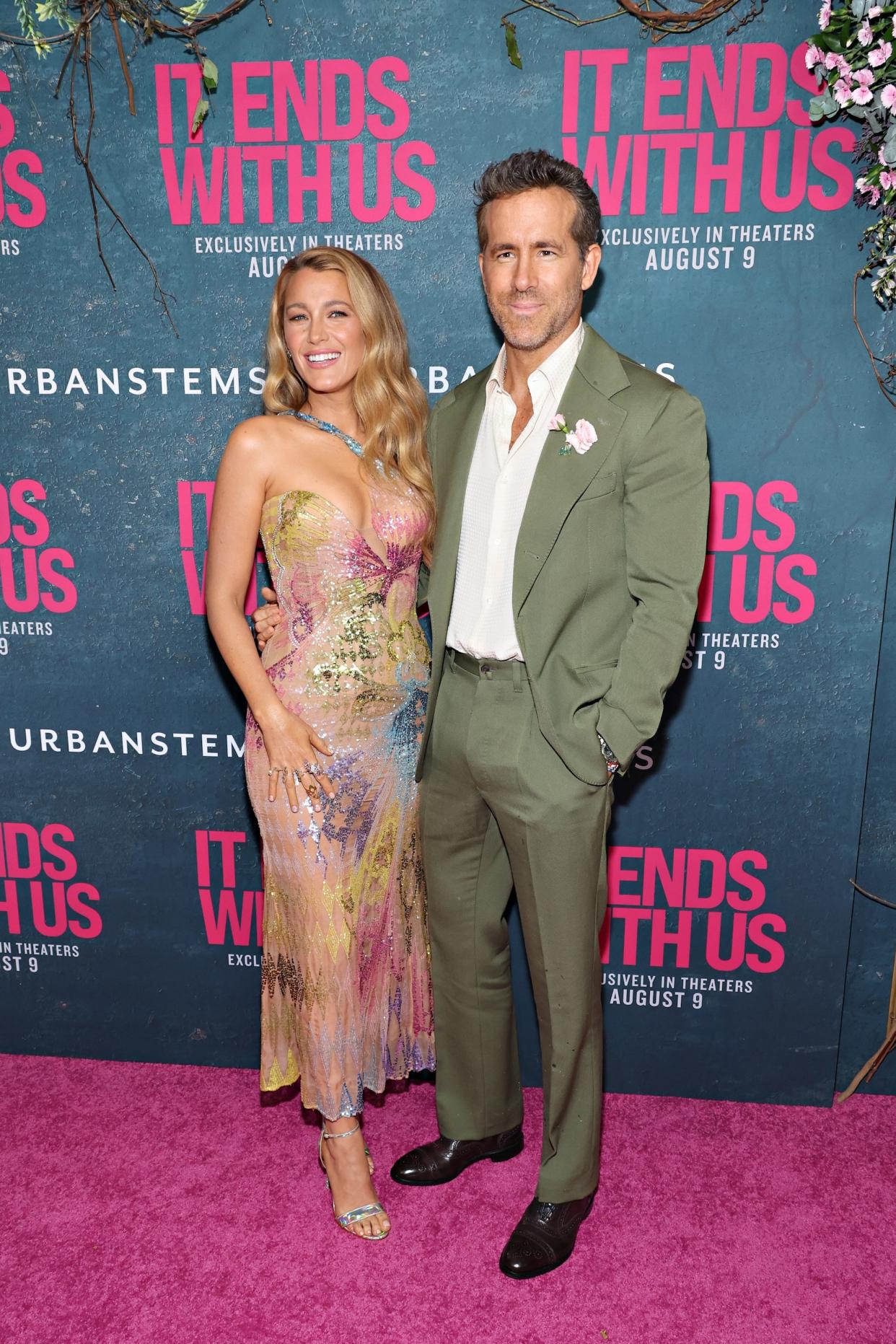 Blake Lively and Ryan Reynolds pose on the "It Ends With Us" pink carpet.