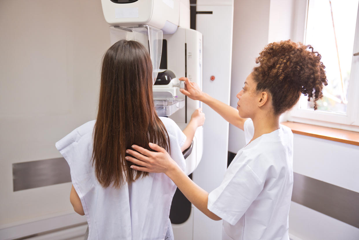 Female doctor and young woman during Mammography test in examination room.