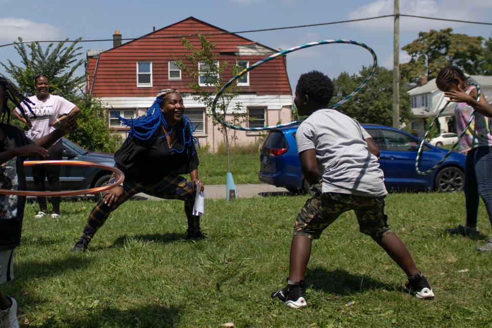 Safiya "Ms. Blue" Jackson, 37, hula hoops alongside one of the children she teaches as part of the Growing Healthy Habits programming at Brilliant Detroit's Littlefield hub in Detroit, on Thursday, July 27, 2023.