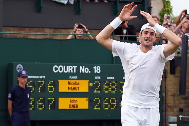 John Isner celebrates winning on the third day of his first round match against Nicolas Mahut of France on Day Four of the Wimbledon Lawn Tennis Championships on June 24, 2010. The match is the longest in Grand Slam history.