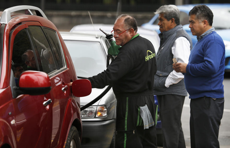 Commuters line up to fill their fuel tanks at a gas station, some of which are limiting how much each client can purchase, in Mexico City, Monday, Jan. 14, 2019. Mexico President Andres Manuel Lopez Obrador has vowed to get the upper hand on fuel thieves and is trying to choke off their supply by taking several major pipelines off line. However, tanker trucks used to deliver the fuel couldn’t distribute fuel at the same levels as the pipelines, triggering shortages and panic buying. (AP Photo/Marco Ugarte)