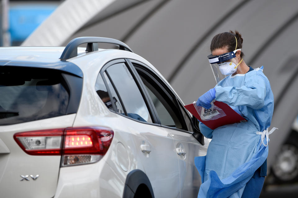 Medical professionals are seen performing COVID-19 tests on members of the public at the Bondi Beach drive-through coronavirus testing centre.