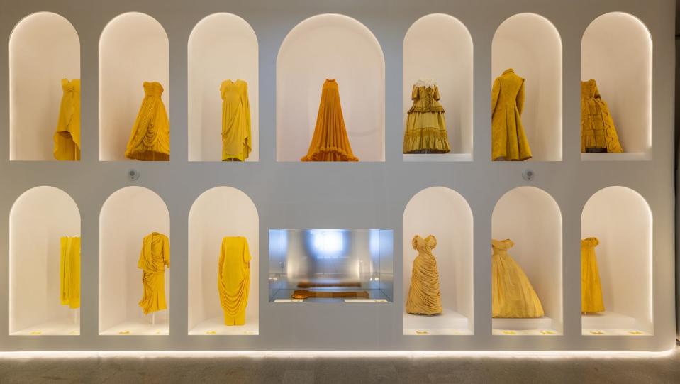 a group of dresses on display