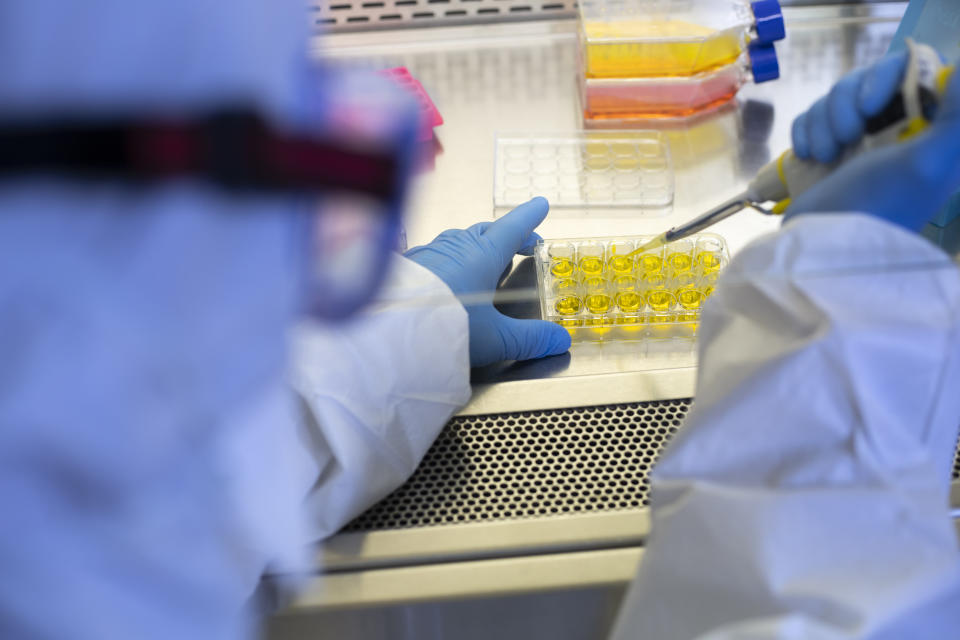 Coronavirus,Blood research,Scientist's Laboratory,Research lab,Analyzing a blood sample in test tube at laboratory with microscope. Medical, pharmaceutical and scientific research and development concept.