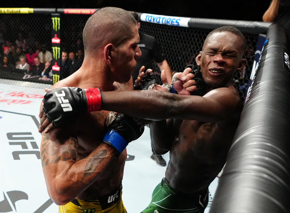Alex Pereira, left, punches Israel Adesanya in the UFC middleweight championship bout during UFC 281 at Madison Square Garden on November 12, 2022 in New York City. (Photo by Jeff Bottari/Zuffa LLC)