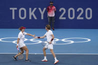 The Russian Olympic Committee mixed doubles team of Anastasia Pavlyuchenkova, left, and Andrey Rublev, play during a semifinals match of the tennis competition at the 2020 Summer Olympics, Friday, July 30, 2021, in Tokyo, Japan. (AP Photo/Seth Wenig)