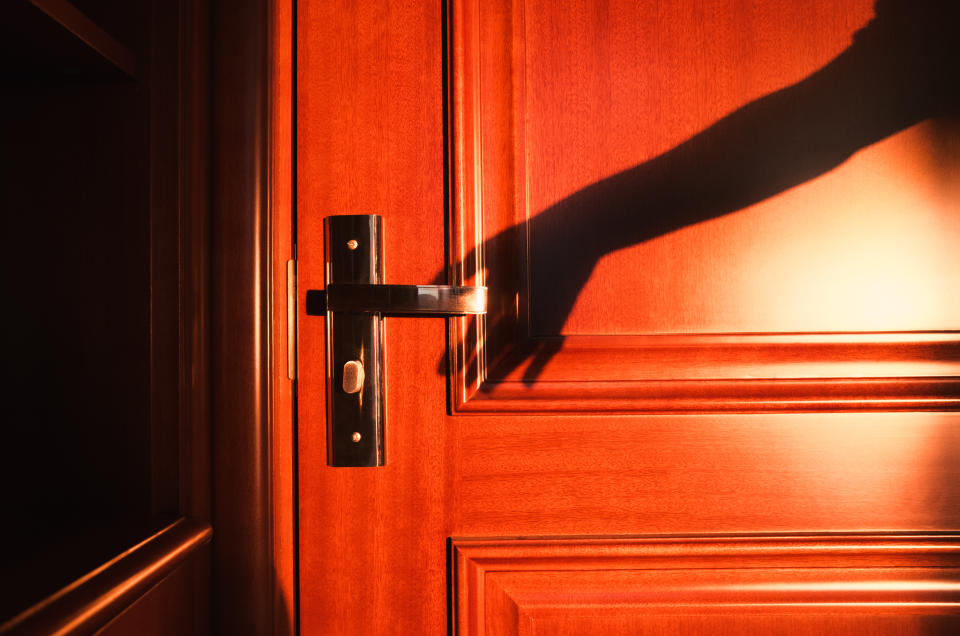 Hand Shadow Reaching Door, Red and Orange Color.