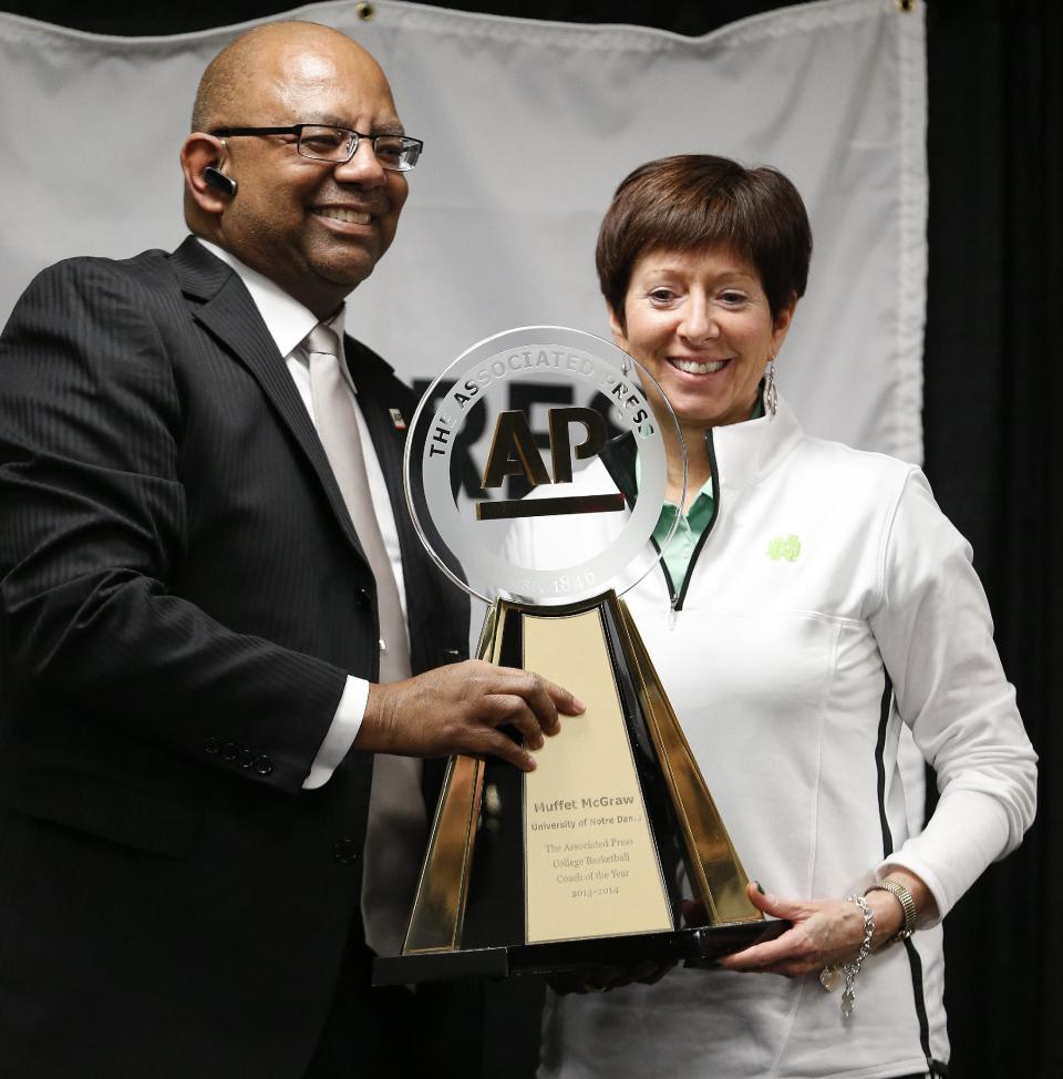Assistant Sports Editor, South Region Oscar Dixon presents the Associated Press college basketball coach of the year trophy to Notre Dame head coach Muffet McGraw at the women's Final Four of the NCAA college basketball tournament, Saturday, April 5, 2014, in Nashville, Tenn. (AP Photo/Mark Humphrey)t