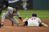 Detroit Tigers shortstop Javier Báez, left, tags out Cleveland Guardians' Will Brennan (17) at second base on an attempted steal in the fourth inning of a baseball game Monday, May 6, 2024, in Cleveland. (AP Photo/Sue Ogrocki)