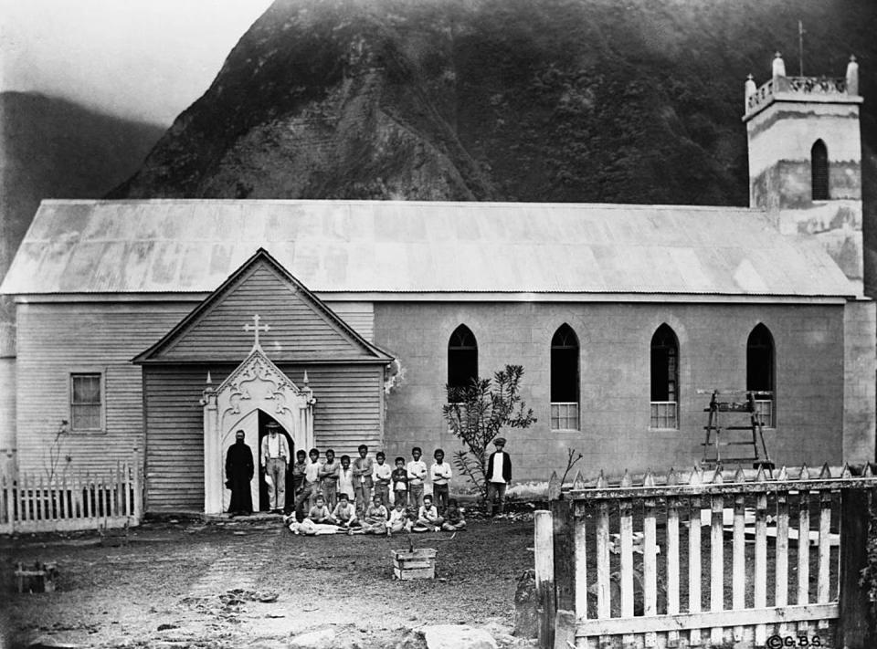<span class="caption">Father Damien stands with patients outside his church on Molokai Island.</span> <span class="attribution"><a class="link " href="https://www.gettyimages.com/detail/news-photo/father-damien-stands-with-patients-outside-his-church-on-news-photo/615231942?adppopup=true" rel="nofollow noopener" target="_blank" data-ylk="slk:Corbis Historical via Getty Images;elm:context_link;itc:0;sec:content-canvas">Corbis Historical via Getty Images</a></span>