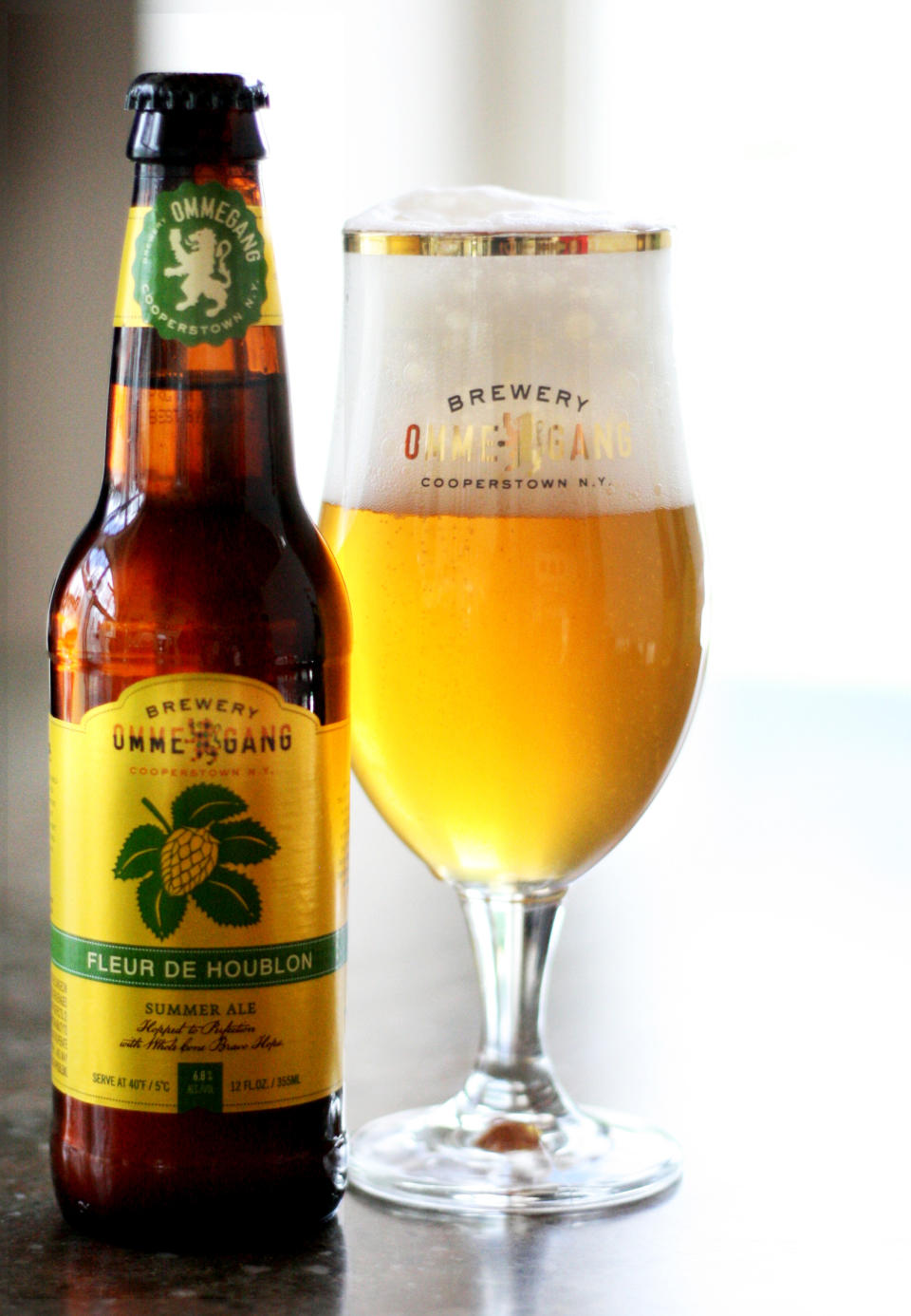 This undated publicity photo provided by Brewery Ommegang/Duvel Moortgat USA, shows a bottle and glass of Fleur de Houblon summer ale. (AP Photo/Brewery Ommegang/Duvel Moortgat USA)