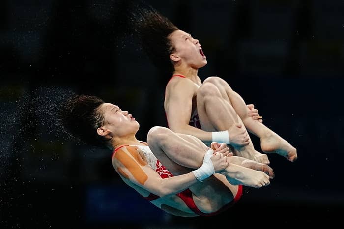 Two divers hurtling through the air