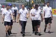Haas driver Mick Schumacher, second from left, of Germany, walks the track with crew members as teams prepare for the Formula One Miami Grand Prix auto race at Miami International Autodrome, Thursday, May 5, 2022, in Miami Gardens, Fla. The race is Sunday, May 8. (AP Photo/Wilfredo Lee)