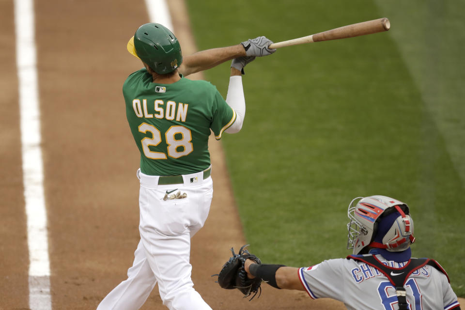 Oakland Athletics' Matt Olson swings for a two run home run off Texas Rangers' Kyle Gibson in the first inning of a baseball game Wednesday, Aug. 5, 2020, in Oakland, Calif. (AP Photo/Ben Margot)