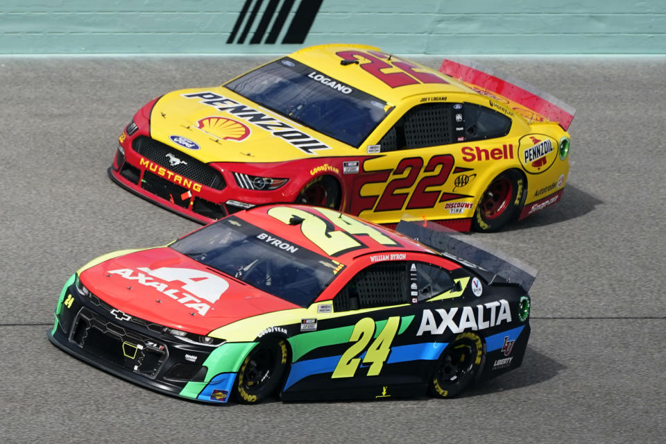 Joey Logano (22) and William Byron (24) battle for position during a NASCAR Cup Series auto race, Sunday, Feb. 28, 2021, in Homestead, Fla. (AP Photo/Wilfredo Lee)