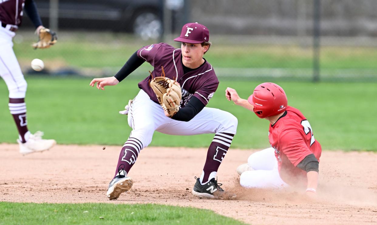 Sean Souza of Falmouth takes the throw as Owen Jones of Barnstable arrives at second.