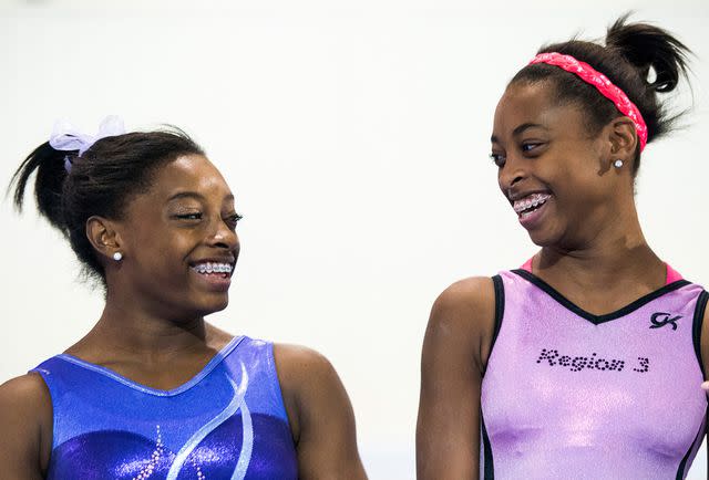 <p>Smiley N. Pool/Houston Chronicle/Getty</p> Biles was placed in foster care with sister Adria (pictured), and two brothers