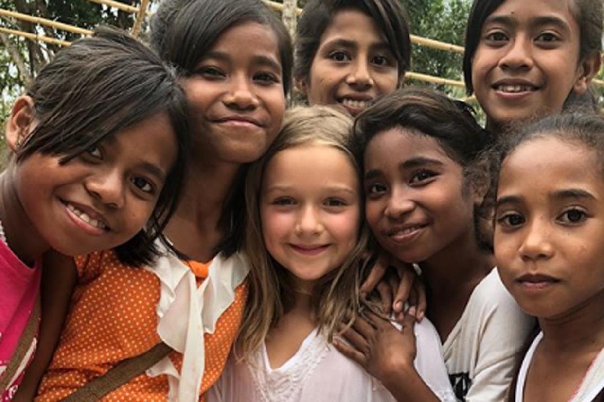 Helping hand: Harper Beckham with a group of students: Instagram/ Victoria Beckham