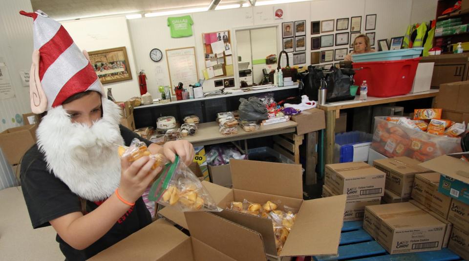 Nine-year-old Ava Ghantt helps out with the food pantry Thursday morning, July 27, 2023, at the Dallas High Shoals Christian Ministry on East Trade Street in Dallas.