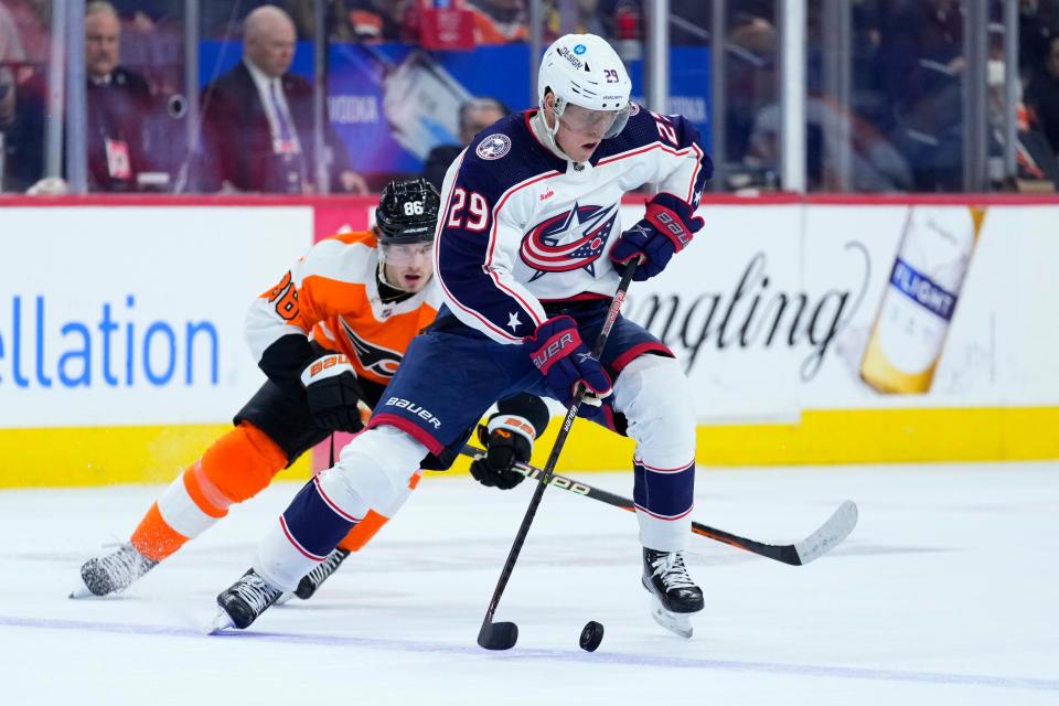 Columbus Blue Jackets' Patrik Laine, right, tries to keep away from Philadelphia Flyers' Joel Farabee during the second period of an NHL hockey game, Tuesday, Dec. 20, 2022, in Philadelphia. (AP Photo/Matt Slocum)