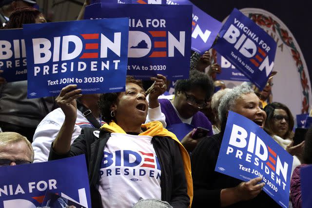 <p>Alex Wong/Getty</p> Supporters cheer for Joe Biden at a Virginia campaign rally in 2020