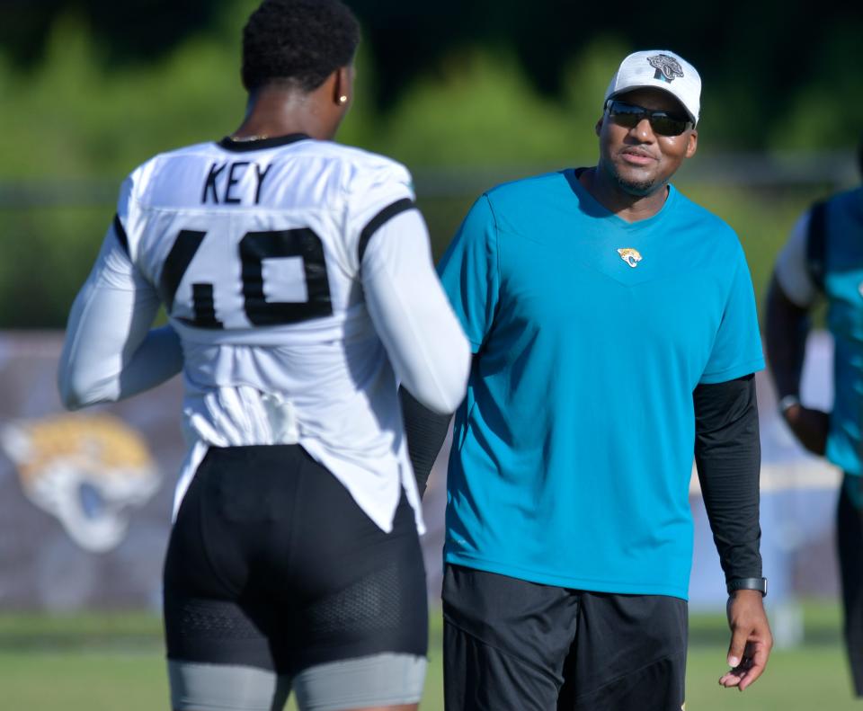 Jaguars defensive coordinator Mike Caldwell talks to Jacksonville Jaguars linebacker Arden Key (49) at a July 27, 2022 training camp session at the Episcopal School of Jacksonville Knight Campus practice fields on Atlantic Blvd.