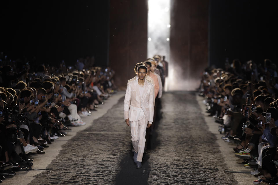 Models wear creations as part of the Ermenegildo Zegna men's Spring-Summer 2020 collection, unveiled during the fashion week, in Milan, Italy, Friday, June 14, 2019. (AP Photo/Luca Bruno)