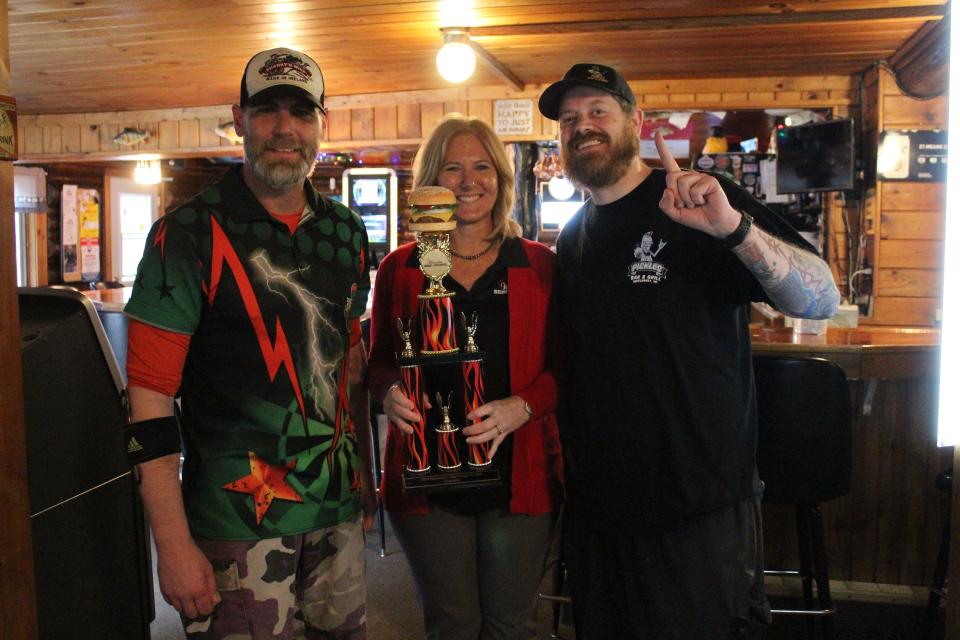 Pickles co-owner Justin Koshak (left), Wisconsin Beef Council Executive Director Tammy Vaassen (center) and Pickles co-owner Dan Linscott with the best burger trophy.