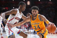 Wyoming guard Hunter Maldonado (24) drives on Arizona guard Dalen Terry during the first half of an NCAA college basketball game Wednesday, Dec. 8, 2021, in Tucson, Ariz. (AP Photo/Rick Scuteri)