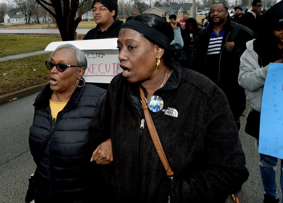 Rosena Washington, right, the mother of Earl Moore Jr., and Brenda Brooks, left, Moore's stepmother, walk arm-in-arm in the Martin Luther King Jr. Day Unity March Jan. 16, 2023.