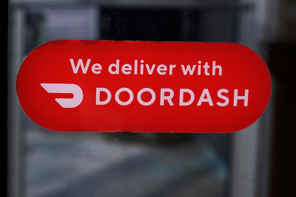 A DoorDash sign is posted on the door of a Dunkin' Donuts franchise, Monday, Feb. 27, 2023, in Methuen, Mass. (AP Photo/Charles Krupa)