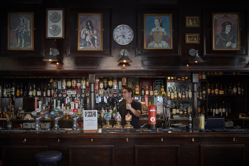 LONDON, ENGLAND - SEPTEMBER 16: A barman pours a drink at the King and Queen Pub in London at the start of the weekend prior to the funeral of Queen Elizabeth II on Monday on September 16, 2022 in London, England. At least 400,000 people are expected to file past the coffin to pay their respects with queues already exceeding 11 hours. Queen Elizabeth II died at Balmoral Castle in Scotland on September 8, 2022, and is succeeded by her eldest son, King Charles III. (Photo by Kiran Ridley/Getty Images)