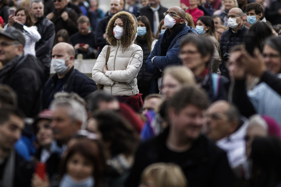 VATICAN CITY, VATICAN - 2020/02/26: People wear face masks as a precaution to the outbreak of Coronavirus in Italy, during the weekly General Audience at St. Peter's Square. The General Audience is held every Wednesday, in Saint Peter's Square, which can accommodate around 80,000 people. (Photo by Giuseppe Ciccia/SOPA Images/LightRocket via Getty Images)