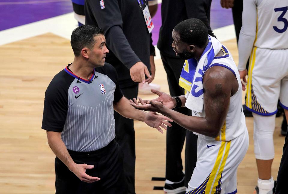 Golden State's Draymond Green makes his case with a referee as he learns he's been ejected after stomping on Domantas Sabonis.