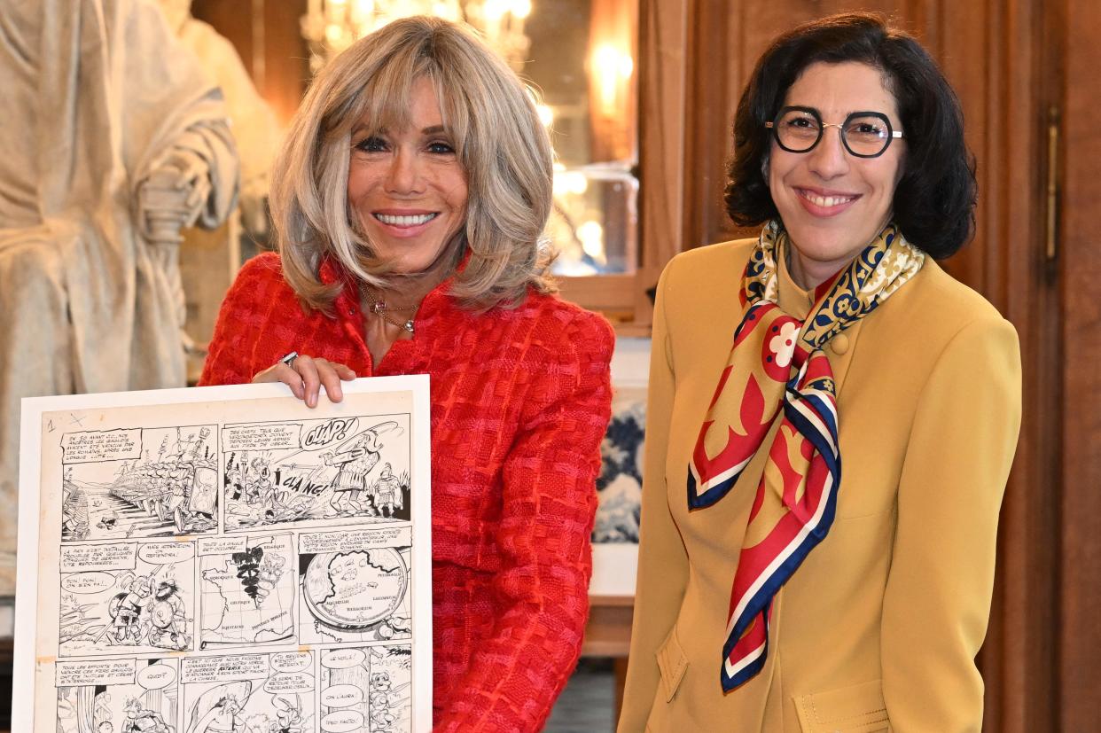 Brigitte Macron holds a comic page next to French Culture Minister Rima Abdul-Malak during a visit to the “Bibliotheque Nationale de France” (POOL/AFP via Getty Images)