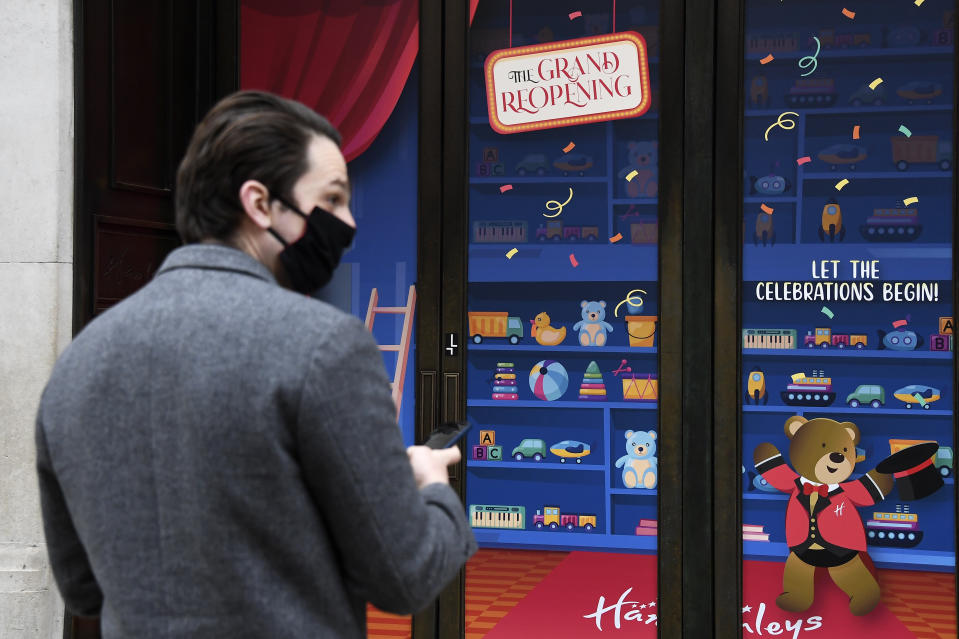 A man stops by a shop window in Regent street in London, Monday, April 12, 2021. Millions of people in England will get their first chance in months for haircuts, casual shopping and restaurant meals on Monday, as the government takes the next step on its lockdown-lifting road map. (AP Photo/Alberto Pezzali)