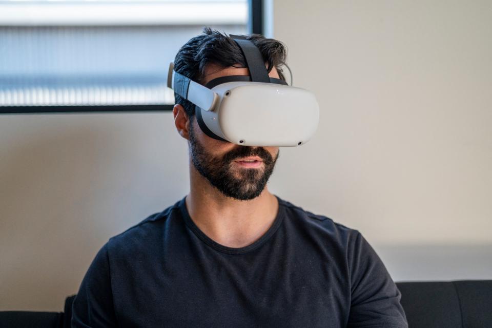 Gavin Menichini, using the Oculus Quest 2 VR headset, gives a demonstration of the Immersed Virtual Reality program which can be used for many applications including virtual meetings at the Immersed offices on January 28, 2022 in Austin, Texas. - While still the stuff of science fiction for most people, forerunners of the metaverse vision for the internet's future are already de rigueur for handfuls of people beyond the gamer and techno-hipster crowds. (Photo by Sergio FLORES / AFP) (Photo by SERGIO FLORES/AFP via Getty Images)