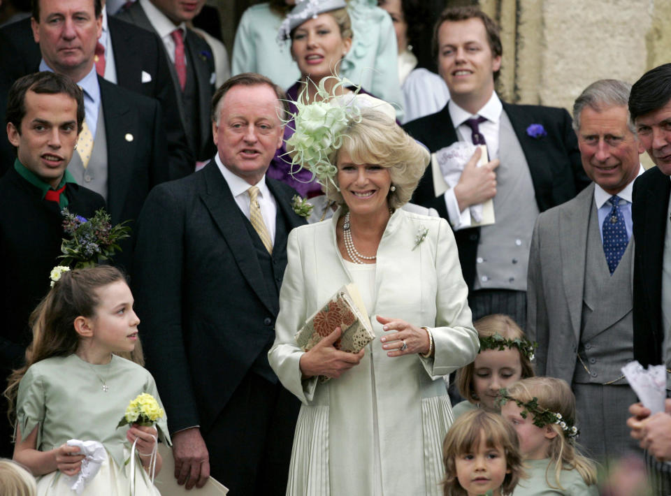 FILE - Britain's Camilla, the Duchess of Cornwall, center, stands beside her husband Prince Charles, right, her former husband Andrew Parker Bowles, center left, and her son Tom, top right, as they leave St Cyriac's Church, after the wedding her daughter Laura Parker Bowles and Harry Lopes in Lacock, Wiltshire, England, Saturday May 6, 2006. (AP Photo/Matt Dunham, File)