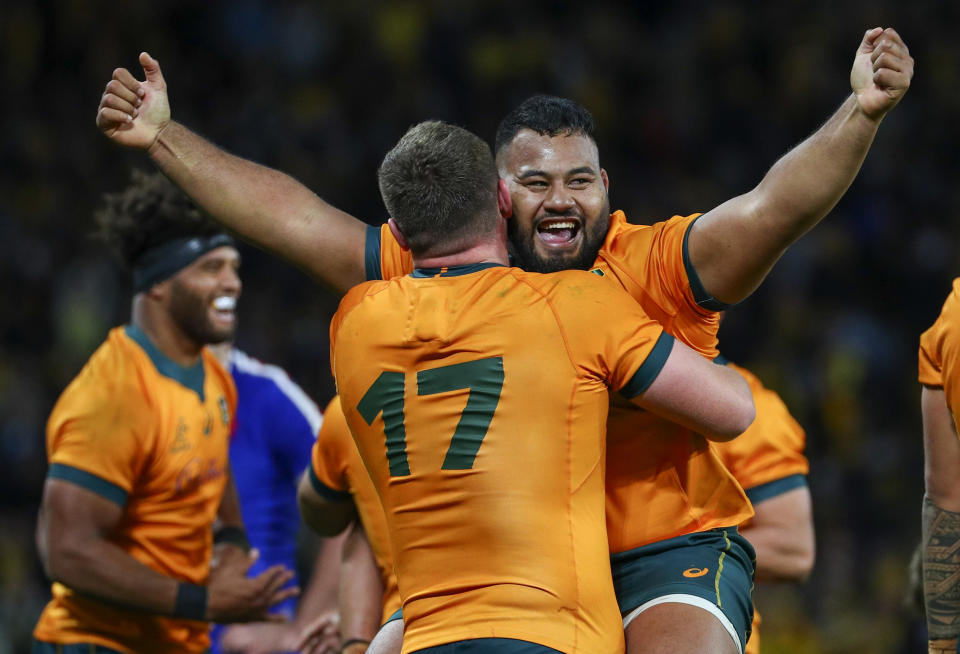 Australia's Taniela Tupou, right, and teammate Angus Bell celebrate after defeating France during the third rugby international between France and Australia at Suncorp Stadium in Brisbane, Australia, Saturday, July 17, 2021. (AP Photo/Tertius Pickard)