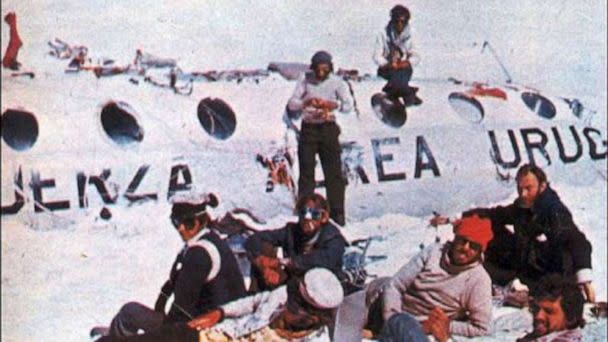 PHOTO: Pancho Delgado (sitting on the fuselage roof) and Roberto Canessa (standing to the right of Pancho) work on stitching together the sleeping bag that the expeditionaries will take on their trek to safety. (Obtained by ABC News)